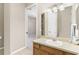 Bright bathroom featuring a single sink vanity with a large mirror and neutral color palette at 33222 Irongate Dr, Leesburg, FL 34788