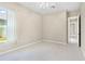 Bright bedroom with a ceiling fan, neutral walls, carpeted floors, and natural light from the window at 33222 Irongate Dr, Leesburg, FL 34788