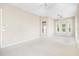 Bright bedroom featuring neutral carpeting, bay windows, and a ceiling fan at 33222 Irongate Dr, Leesburg, FL 34788