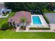Community pool with lounge chairs, palm trees, and a shaded area at 33222 Irongate Dr, Leesburg, FL 34788