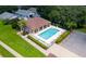 Aerial view of the community pool with lounge chairs and landscaping at 33222 Irongate Dr, Leesburg, FL 34788
