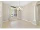 Dining room showcases natural light, tile flooring, and decorative chandelier at 33222 Irongate Dr, Leesburg, FL 34788