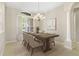 Formal dining area with chandelier lighting, neutral tones, and large windows at 33222 Irongate Dr, Leesburg, FL 34788