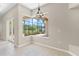 Dining area showcases tile flooring, a screened window, and outdoor views at 33222 Irongate Dr, Leesburg, FL 34788