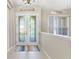 Bright foyer with a decorative glass front door, tiled flooring, and neutral walls at 33222 Irongate Dr, Leesburg, FL 34788