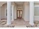 Inviting entryway showcasing grand columns and a detailed glass-paneled front door at 33222 Irongate Dr, Leesburg, FL 34788