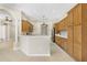 The kitchen features tile floors, wood cabinetry, and an open layout at 33222 Irongate Dr, Leesburg, FL 34788