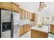 Spacious kitchen with stainless steel fridge, abundant cabinetry and island at 33222 Irongate Dr, Leesburg, FL 34788