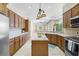 Open kitchen with stainless appliances, island, and views of the living area at 33222 Irongate Dr, Leesburg, FL 34788