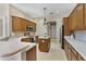 Charming kitchen featuring wood cabinets, stainless appliances, and a convenient center island at 33222 Irongate Dr, Leesburg, FL 34788