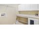 Functional laundry room with built-in shelving and counter space for folding at 33222 Irongate Dr, Leesburg, FL 34788