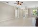 Open living room with tile flooring, decorative columns, and a view to the entry at 33222 Irongate Dr, Leesburg, FL 34788