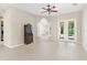 Open living room features tile flooring, ceiling fan, and french doors to the outside at 33222 Irongate Dr, Leesburg, FL 34788