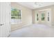 A bright primary bedroom featuring neutral walls, plush carpeting, a ceiling fan, and a window bay at 33222 Irongate Dr, Leesburg, FL 34788