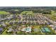 Aerial view of a community with a pool, playground, basketball, and tennis courts nestled among well-kept homes at 3354 Truluck Pl, Oxford, FL 34484