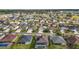Aerial view of a residential neighborhood displaying neatly arranged homes with manicured lawns and community amenities at 3354 Truluck Pl, Oxford, FL 34484