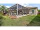 Spacious backyard with screened-in lanai featuring an in-ground pool, perfect for outdoor living at 3354 Truluck Pl, Oxford, FL 34484