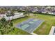 Aerial view showing a basketball court adjacent to a community pool and playground in a residential area at 3354 Truluck Pl, Oxford, FL 34484