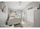 Charming bedroom features a white-painted wood bed frame, a ceiling fan, and ample natural light at 3354 Truluck Pl, Oxford, FL 34484