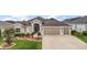 Charming single-story home with a well-manicured front yard and a three car garage at 3354 Truluck Pl, Oxford, FL 34484