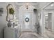 Elegant foyer featuring a chandelier, decorative mirror, and a glimpse of a bathroom at 3354 Truluck Pl, Oxford, FL 34484