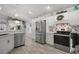 Modern kitchen equipped with stainless steel appliances, white cabinetry, and tiled backsplash at 3354 Truluck Pl, Oxford, FL 34484