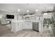 Bright kitchen features white cabinetry, stainless steel appliances, and hardwood floors at 3354 Truluck Pl, Oxford, FL 34484