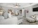 The primary bedroom features a sitting area, tray ceiling, and hardwood floors at 3354 Truluck Pl, Oxford, FL 34484