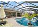 Inviting screened-in pool with patio furniture offers the ideal space for relaxation and entertaining at 3354 Truluck Pl, Oxford, FL 34484