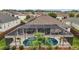 An aerial view of a screened in pool, patio, and lush landscaping in the backyard at 3354 Truluck Pl, Oxford, FL 34484