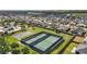 Aerial view featuring well-maintained tennis and basketball courts within a residential community at 3354 Truluck Pl, Oxford, FL 34484