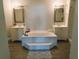 Elegant bathroom features a large soaking tub with dual vanities and modern fixtures at 33710 Linda Ln, Leesburg, FL 34748