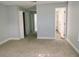 Spacious bedroom featuring soft carpet, neutral walls, and closet doors at 33710 Linda Ln, Leesburg, FL 34748
