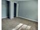 Cozy bedroom featuring neutral walls, soft carpet, and a closet at 33710 Linda Ln, Leesburg, FL 34748