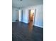 Spacious bedroom featuring hardwood floors, neutral paint, and views to an en suite bath at 33710 Linda Ln, Leesburg, FL 34748