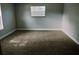 Bright bedroom featuring a window and plush carpeting at 33710 Linda Ln, Leesburg, FL 34748