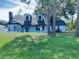 Charming two-story home featuring a front yard, classic siding, and a welcoming entrance at 33710 Linda Ln, Leesburg, FL 34748