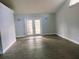 Living room featuring lovely french doors and modern flooring at 33710 Linda Ln, Leesburg, FL 34748