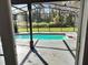 Screened-in pool with a tranquil view of the lush backyard provides a private outdoor retreat at 33710 Linda Ln, Leesburg, FL 34748