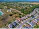 Beautiful aerial view of a suburban neighborhood next to fields and tree lines at 34107 Alameda Dr, Sorrento, FL 32776