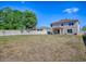 A view of the house from the spacious backyard, surrounded by a white fence at 34107 Alameda Dr, Sorrento, FL 32776