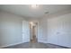 This bedroom features gray wood-look flooring, a double-door closet, and an open doorway leading to the rest of the house at 34107 Alameda Dr, Sorrento, FL 32776