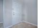 A bright entryway showcases a white paneled front door and neutral-toned tile flooring for a clean and welcoming entrance at 34107 Alameda Dr, Sorrento, FL 32776