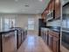 Kitchen view showcasing the stainless appliances, dark counters and tile floor at 34107 Alameda Dr, Sorrento, FL 32776