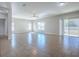 Bright living room with ceramic tile flooring, several windows, and sliding glass door at 34107 Alameda Dr, Sorrento, FL 32776