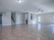View of a large living room with ceramic tile flooring leading to staircase and front door at 34107 Alameda Dr, Sorrento, FL 32776
