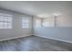 Open living area with hardwood floors, neutral walls, and plenty of natural light at 34107 Alameda Dr, Sorrento, FL 32776
