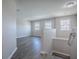 Upstairs loft with wood flooring, multiple windows, and hanging light fixture at 34107 Alameda Dr, Sorrento, FL 32776