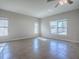 An empty room with tile flooring and three windows providing ample natural light at 34107 Alameda Dr, Sorrento, FL 32776