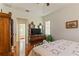 Spacious bedroom has wood floors, and features an ensuite bathroom and walk-in closet at 3440 Tumbling River Dr, Clermont, FL 34711